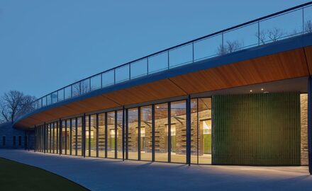 a faceted glass wall in new york using 13ft tall glass pivot doors