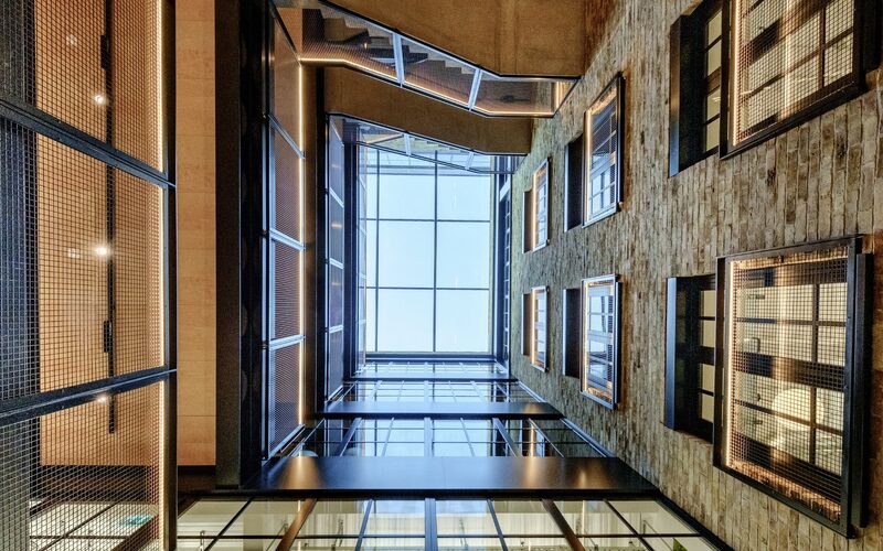 a large structural glass roof at the top of a warehouse atrium - glass roofs